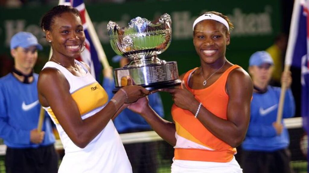 Serena and Venus celebrating AO doubles trophy.